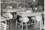 American schoolchildren practice taking shelter under their desks.