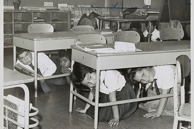 American schoolchildren practice taking shelter under their desks.