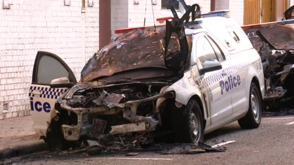 Three police cars were destroyed in the arson attack - ABC News