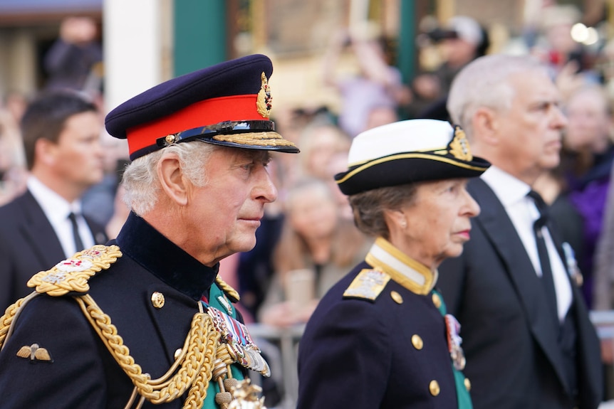 King Charles walks behind his mother's coffin with Princess Anne and Prince Andrew.