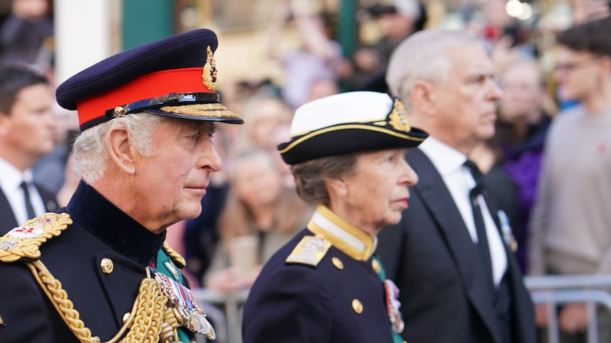King Charles walks behind his mother's coffin with Princess Anne and Prince Andrew.