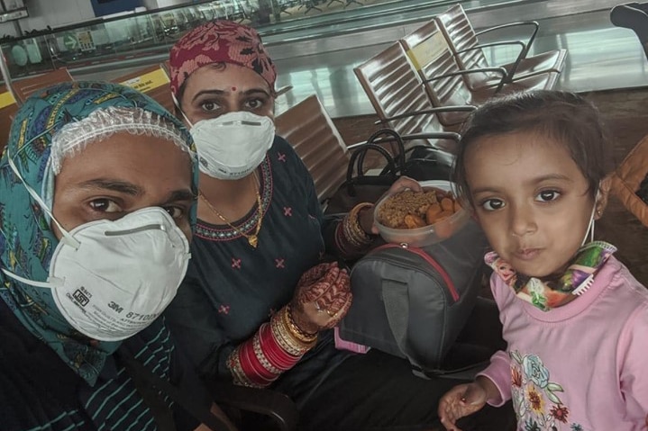 Shailesh Thorat, Neha Soni and Prisha in an airport with masks on