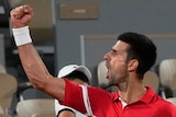 Tennis superstar Novak Djokovic screams out in victory as he punches the air after a match at the French Open.