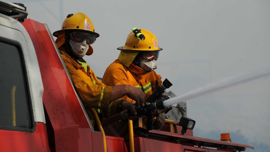 Firefighters strengthen containment lines on the Darling Causeway near the township of Bell in the NSW Blue Mountains.