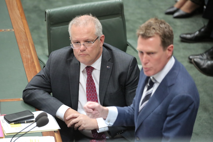 Scott Morrison listens as Christian Porter speaks during Question Time inside the Federal Parliament