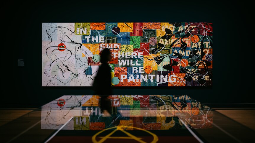 Photo of a gallery view of artwork mosaic, with text "In The End There Will Be Painting"