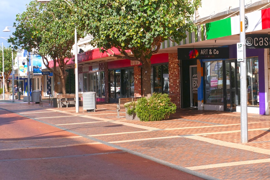 A strip of shops on an otherwise empty street