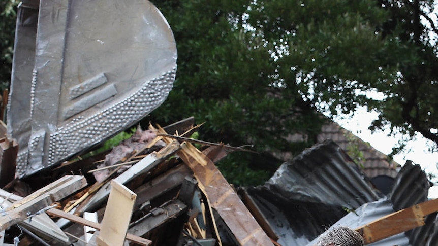 A Christchurch resident walks around his demolished house