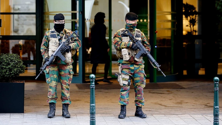 Belgian soldiers stand guard outside Brussels hotel