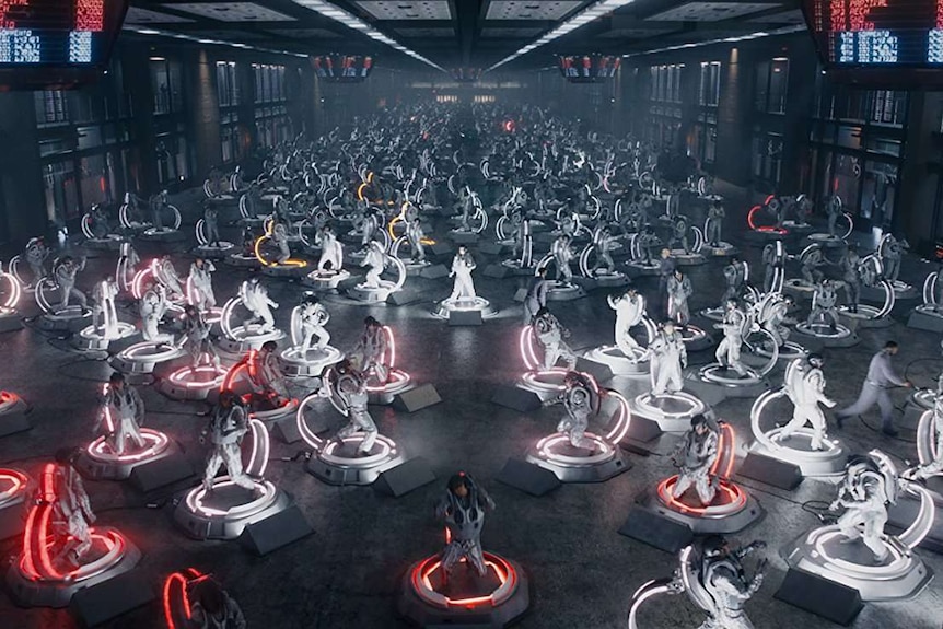 Colour still image from 2018 film Ready Player One of a stadium or hall filled with virtual reality gamers.