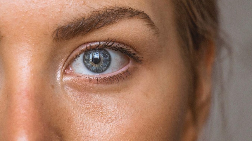A close-up of a woman's skin and eyes.