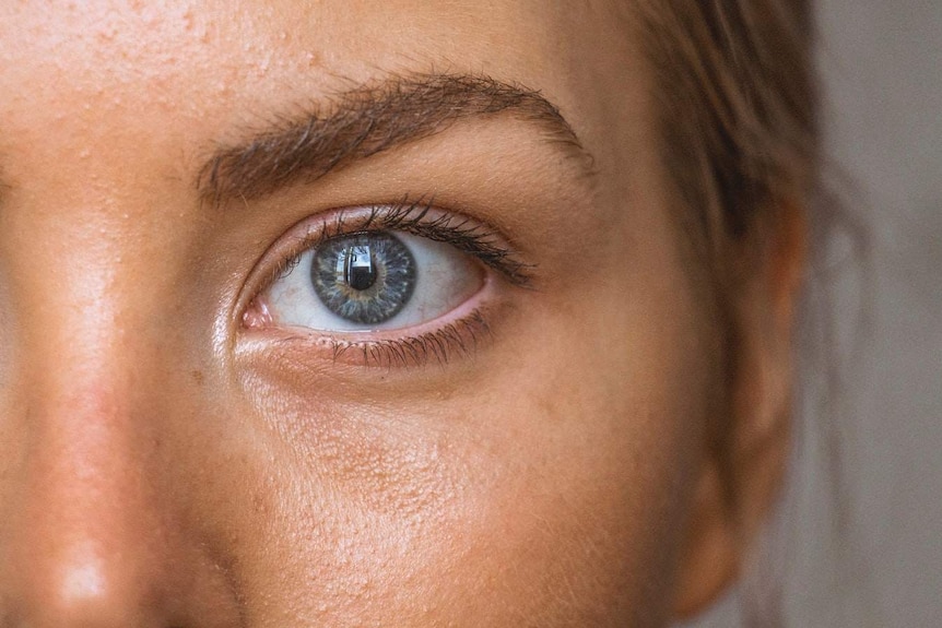 A close-up of a woman's skin and eyes.