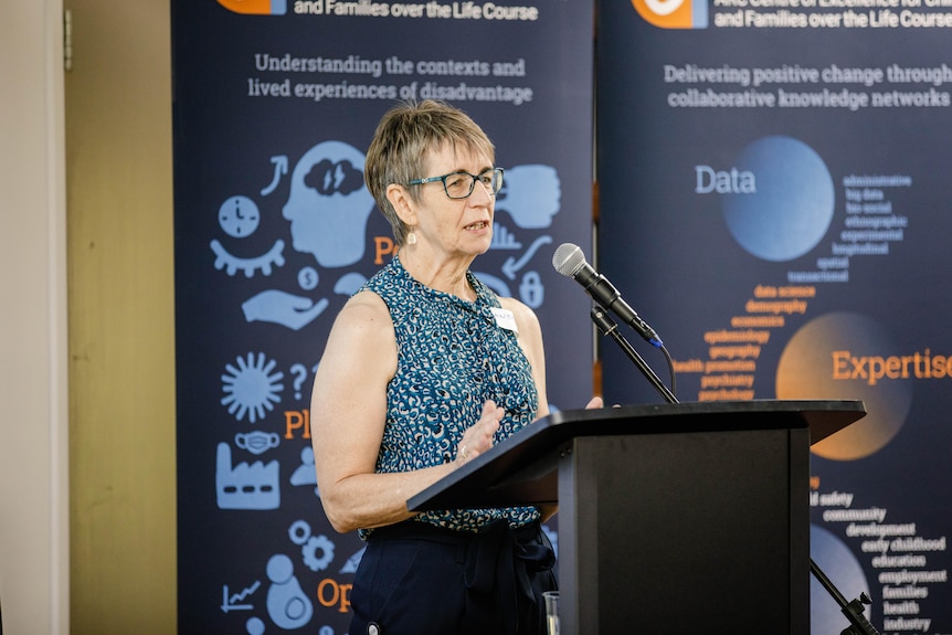 Janeen Baxter speaks at a podium.