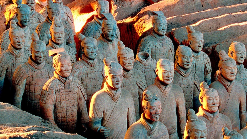 Close-up of terracotta warriors in excavation site.