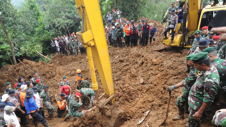 Rescuers recover the body of a victim of a landslide in Indonesia.