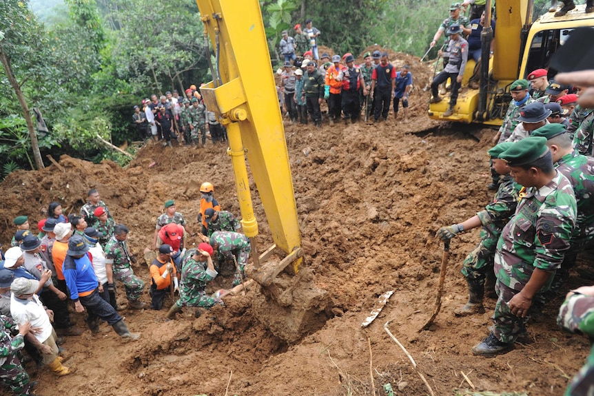 Rescuers recover the body of a victim of a landslide in Indonesia.