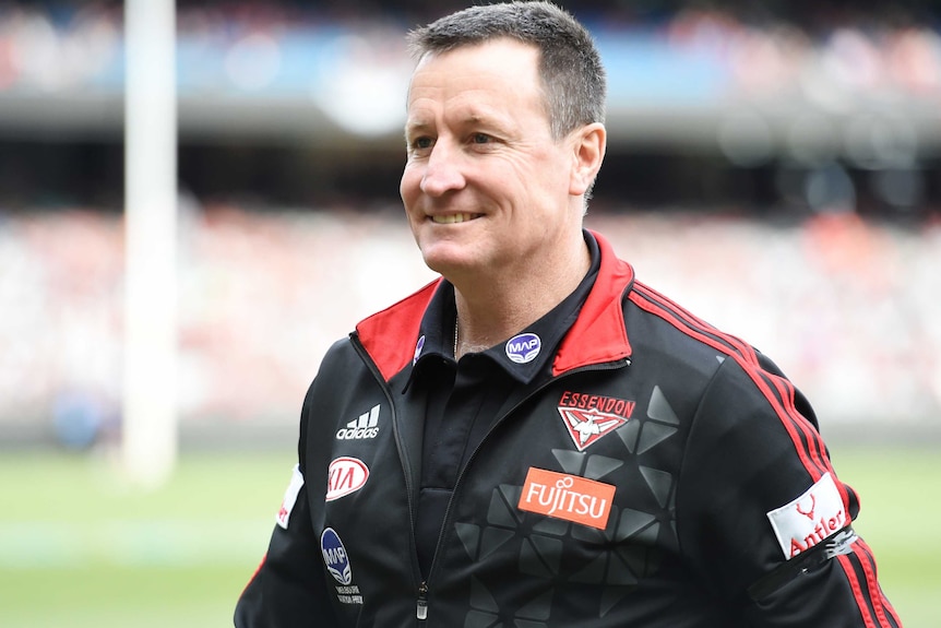 A mid shot of John Worsfold in a Bombers jacket.