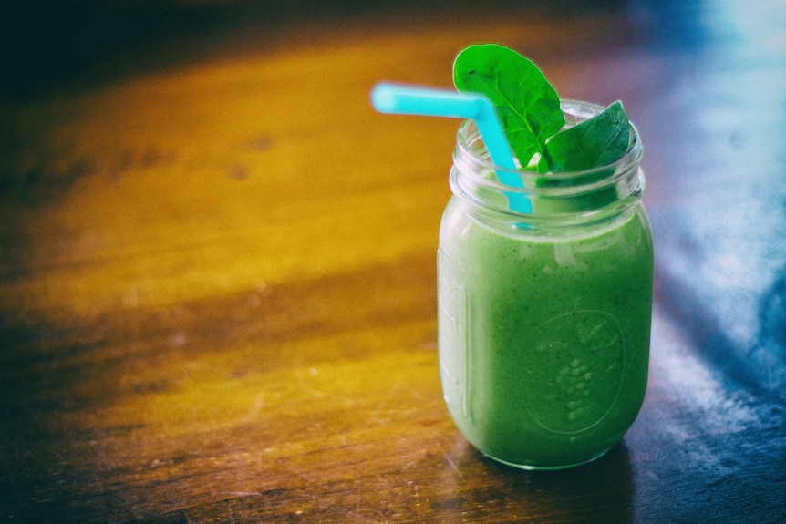 A green smoothie on a bench