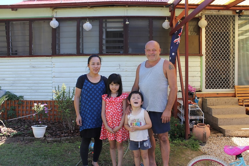 Shane Steddman standing in front of his house with his wife Naomi and children Sarah and Ricky.