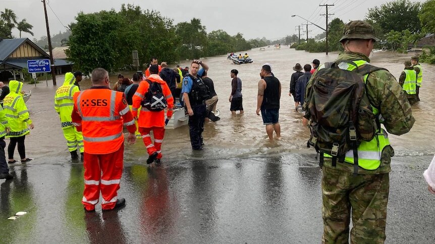 First responders standing in flood waters during a rescue in Lismore, in the Northern Rivers of NSW.