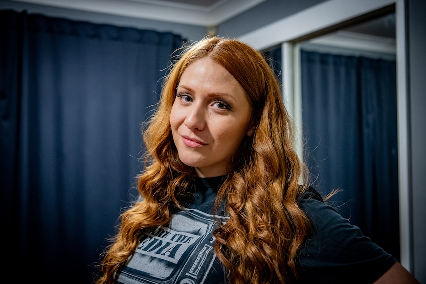 Close up of a woman's face with red hair.