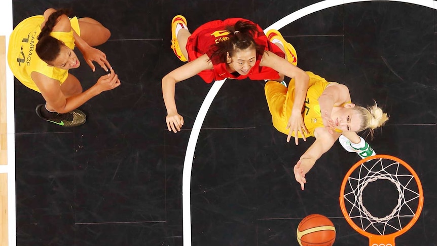 China's Song Gao defends Australia's Lauren Jackson as Elizabeth Cambage looks on.