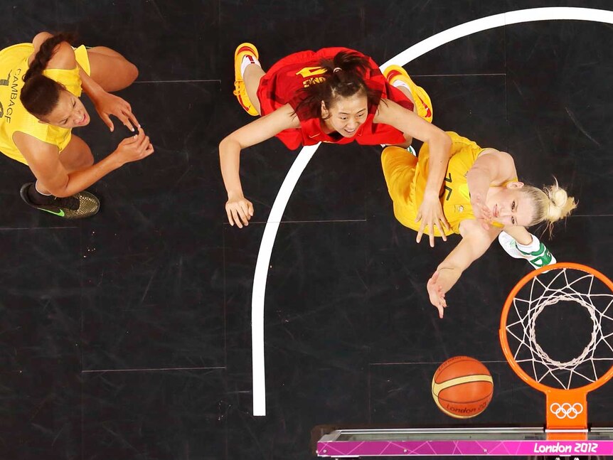 China's Song Gao defends Australia's Lauren Jackson as Elizabeth Cambage looks on.