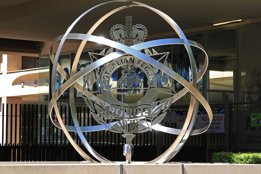 A metal sculpture with the Australian Federal Police insignia.