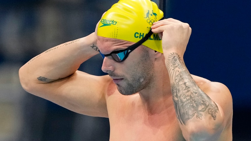 Kyle Chalmers holds his goggles before a swimming race at the Tokyo Olympics.