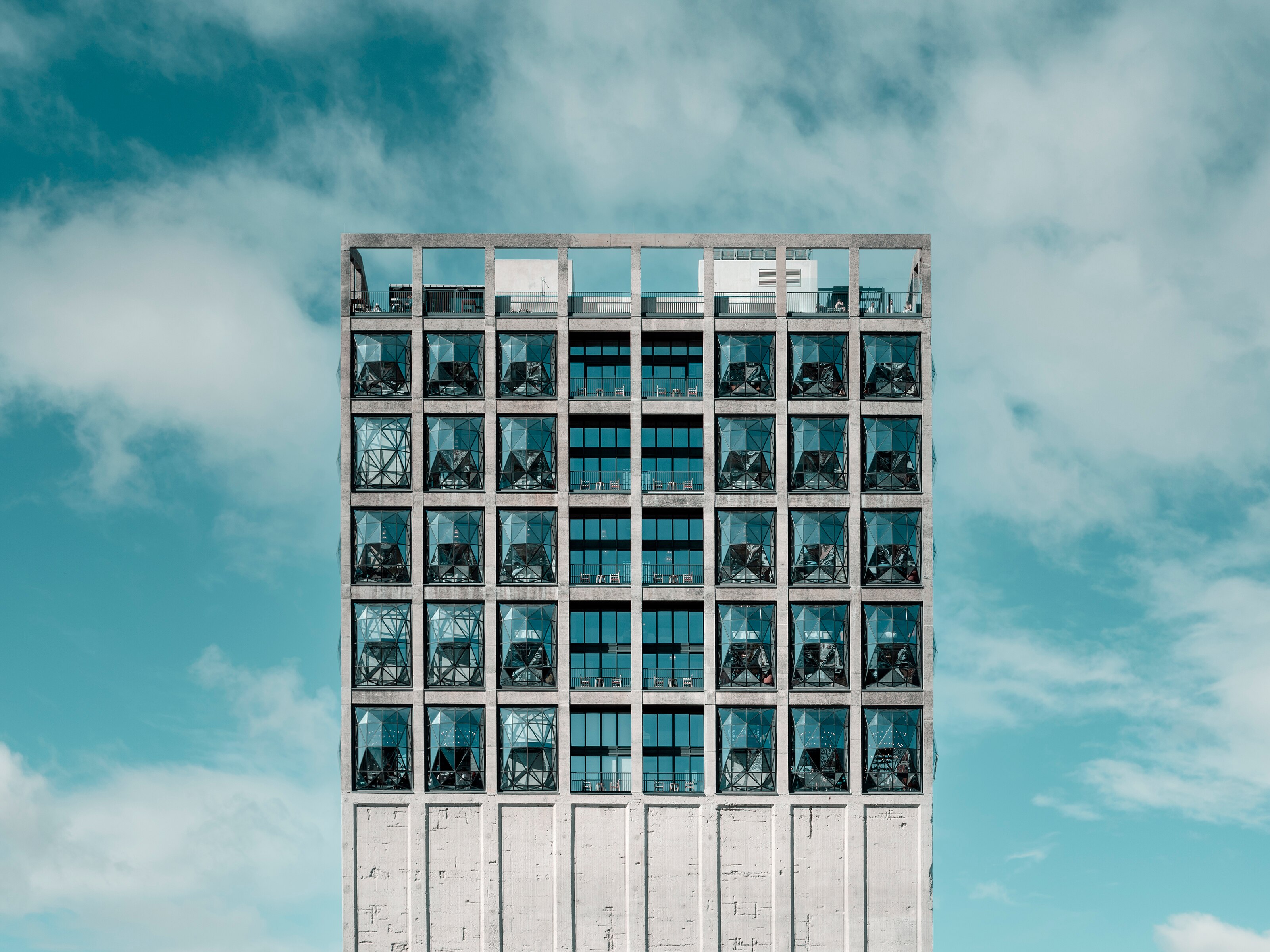 A building with many rectangular windows against a sky.