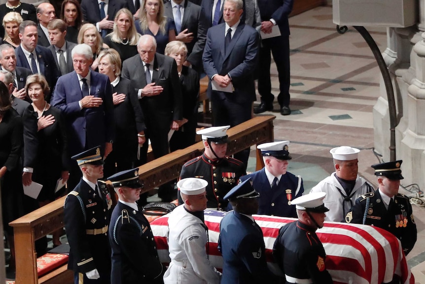 Guests watch as the casket arrives.