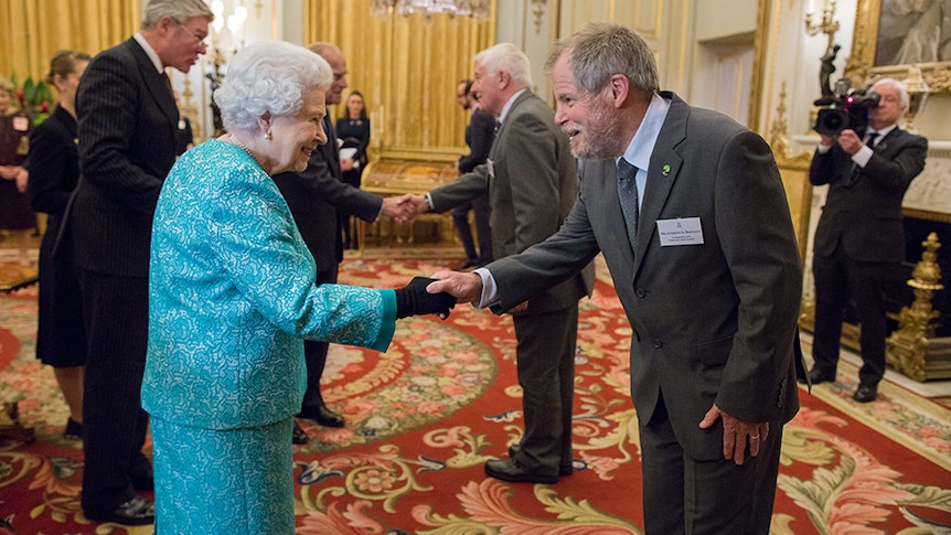 The Queen shakes hand with a bearded man