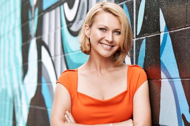 Portrait of Mariana in front of a graffiti wall