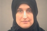 A mugshot of a woman wearing a headscarf