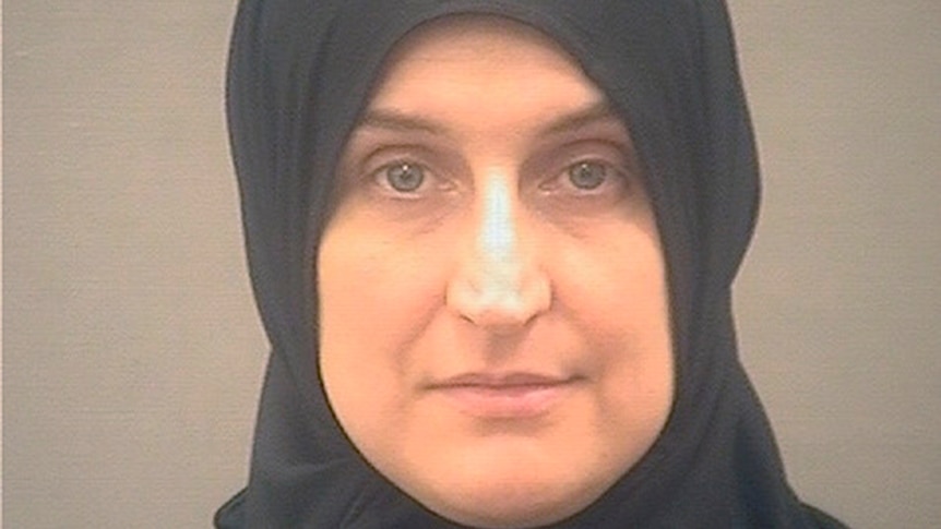 A mugshot of a woman wearing a headscarf
