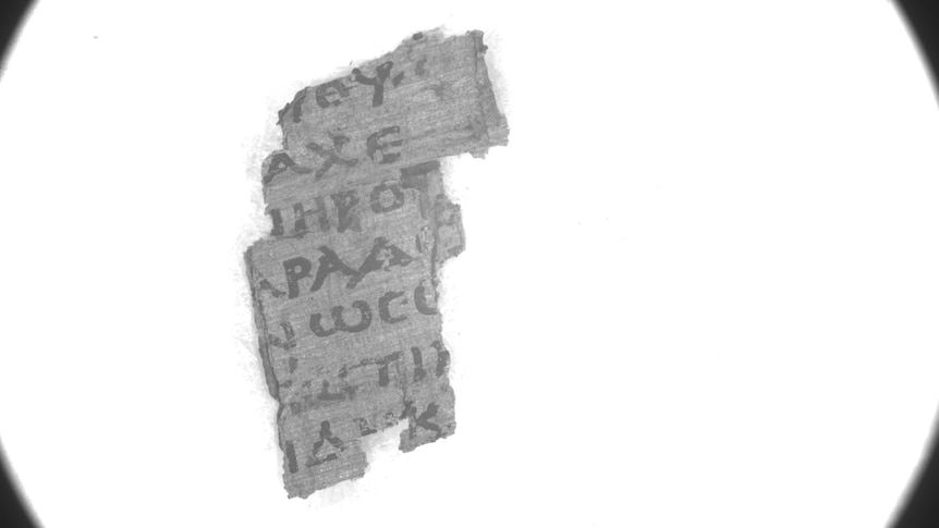 Greek letters visible on a fragment of papyrus