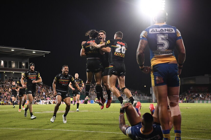 The Penrith Panthers leap in the air after a try which was later overturned.