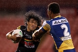 A man fends a defender during a rugby league match