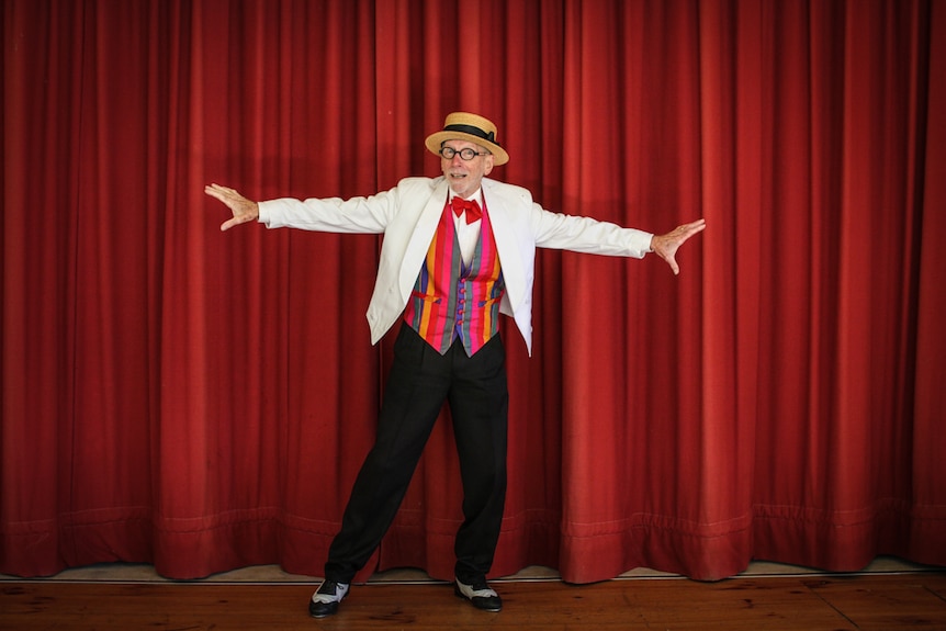 Octogenarian David Watson in his fancy outfit tap dancing on stage.