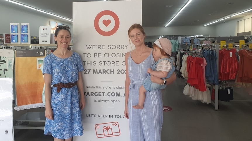 Two women and a baby outside a Country Target store