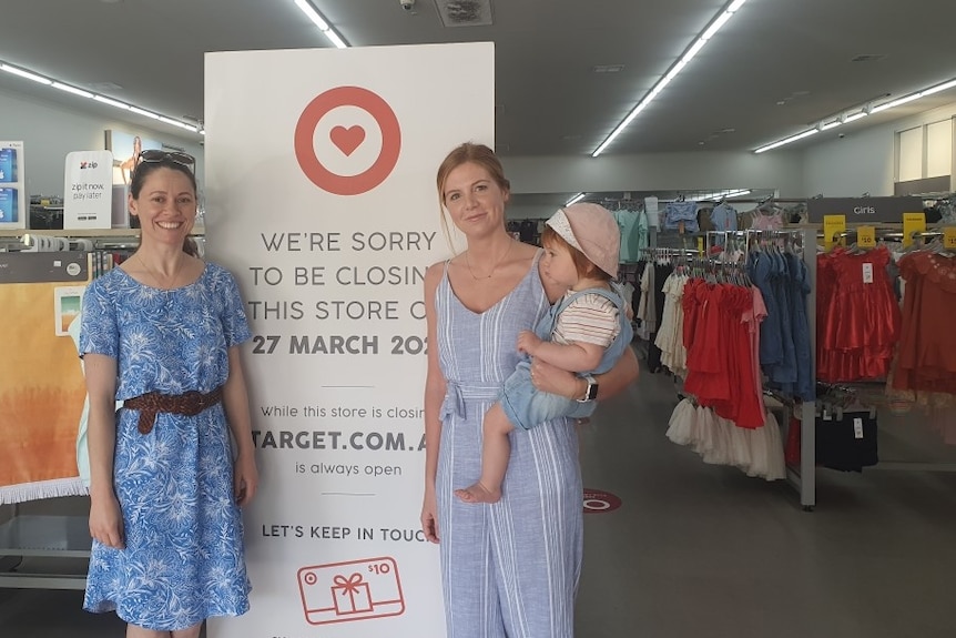 Two women and a baby outside a Country Target store