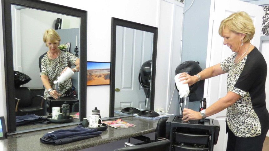 Rhonda Weeks prepares for a day at work at her hairdresser salon