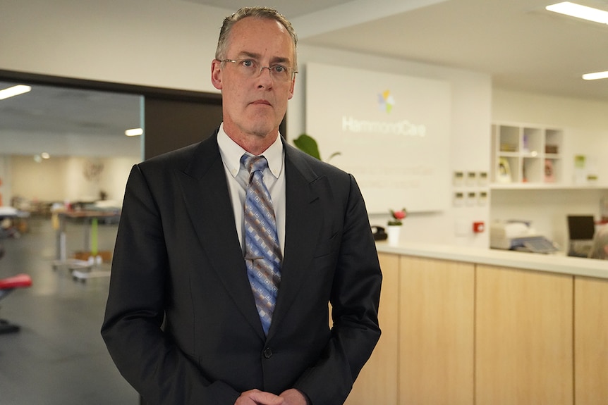 Man in front of reception desk.