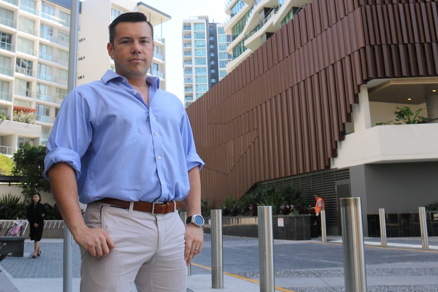 Photo of Brisbane real estate agent and building marketer Nick Buick taken in front of high rise buildings at Portside.