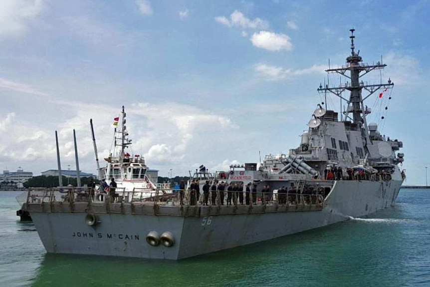 A navy destroyer ship with the name John S McCain written on the back.