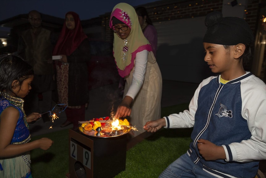 A Muslim girl and a Sikh boy celebrate Diwali.