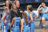 Canberra Capitals coach Carrie Graf speaks with players courtside.