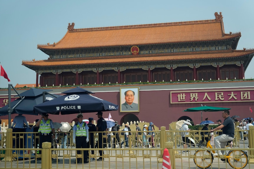 Police stand outside an ornate oriental-style building