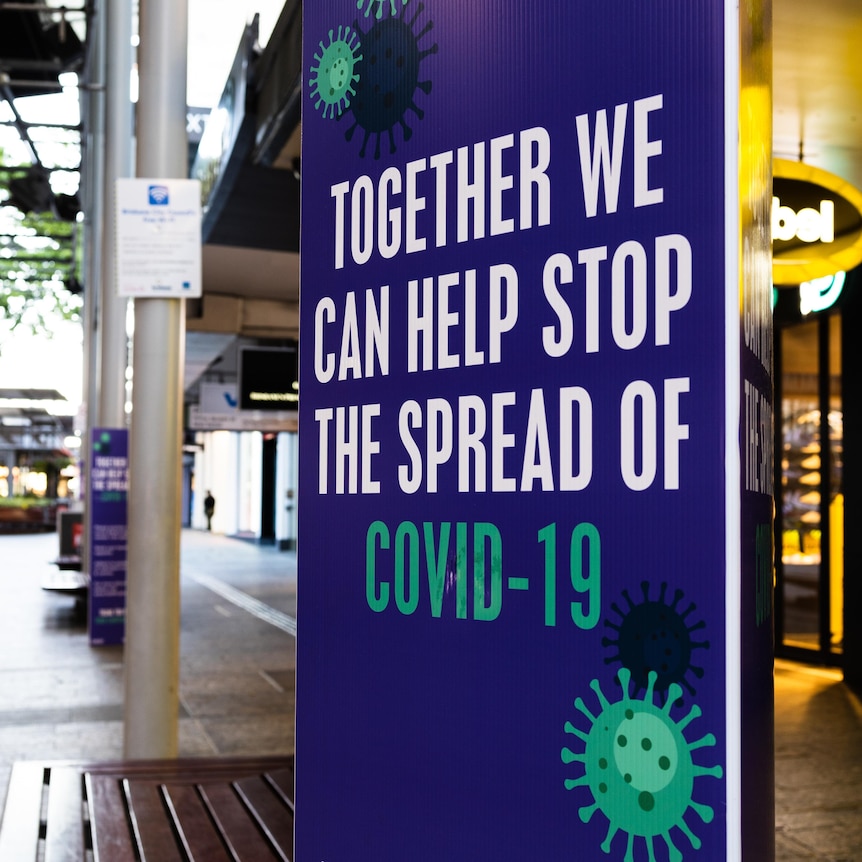 A public sign reads 'Together we can help stop the spread of COVID-19'.