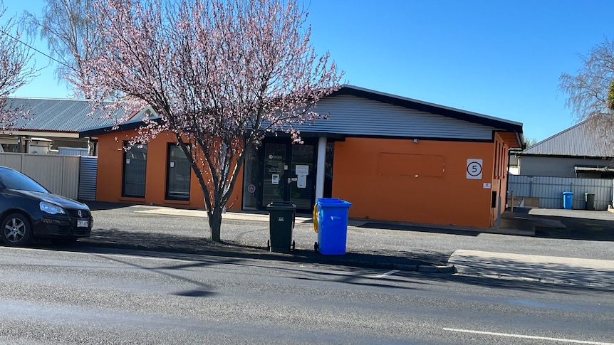 An orange building on a street